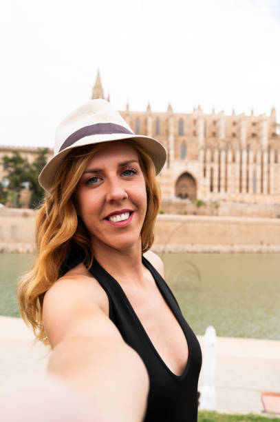 istock Tourist taking selfie with palma cathedral in background 2161364158