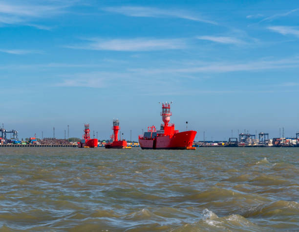 View from the middle of Harwich Harbour, which separates Felixstowe in Suffolk and Harwich in Essex, Eastern England. In the middle of the harbour three redundant lightships are moored. Port of Felixstowe - ‘The Port of Britain’ - is one of Europe’s largest and busiest container ports and the biggest in the UK.
