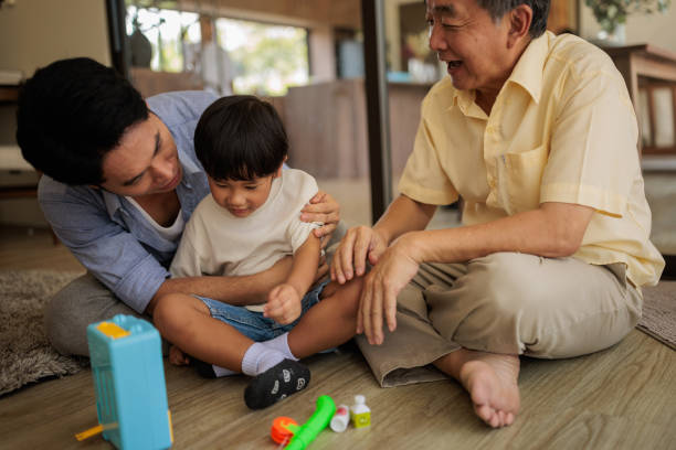Grandpa teaching son how to repair toy car