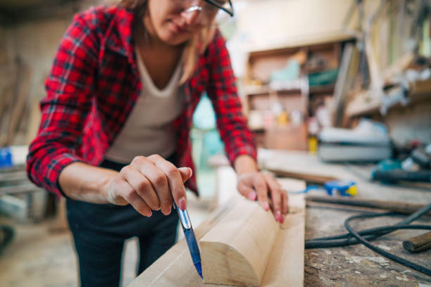 istock young female carpenter takes measures 2161372525