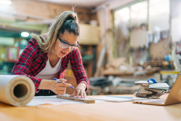 istock young female carpenter takes measures 2161372967