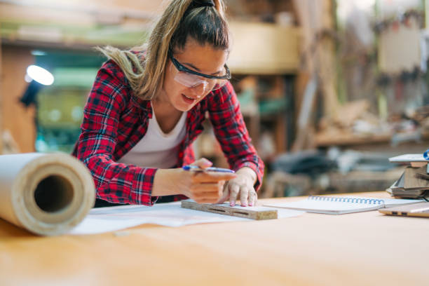 istock young female carpenter takes measures 2161373022
