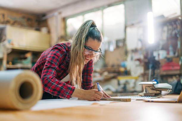 istock young female carpenter takes measures 2161373200
