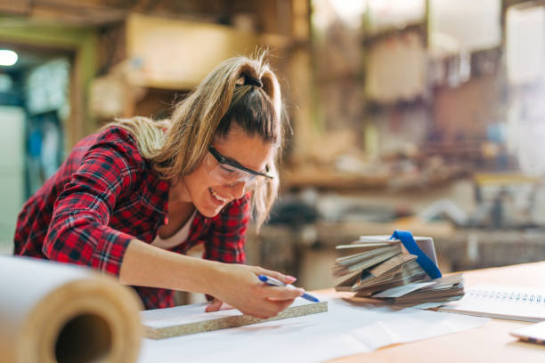 istock young female carpenter takes measures 2161374012
