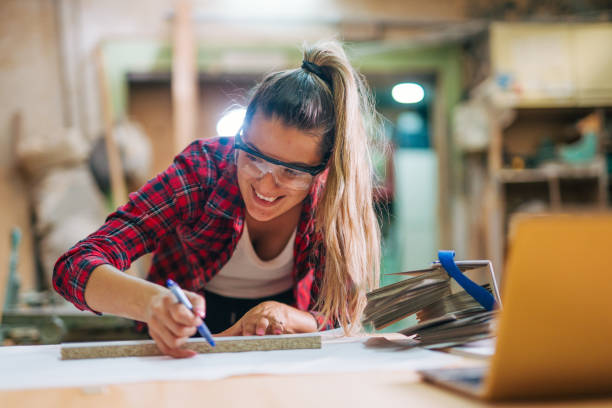 istock young female carpenter takes measures 2161374170