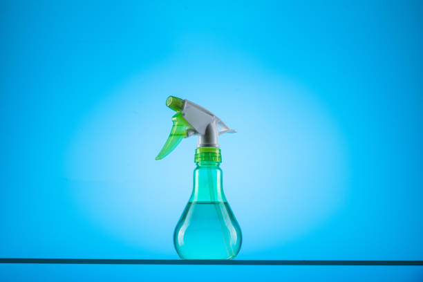 Spray bottle on a blue background. Water sprayer. Bottled water. Front view.