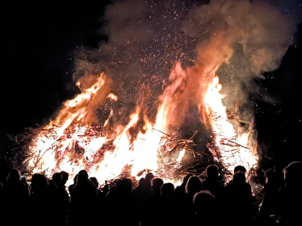 istock A huge easter fire blazes at night, captivating a crowd with the flames, under a dark sky 2161379541