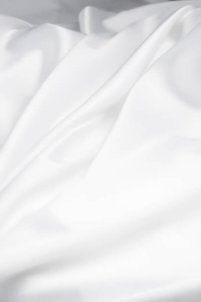 istock White Satin Silky Cloth. Fabric Textile Drape with Crease Wavy Folds with Soft Waves. Luxurious background design. 2161379867