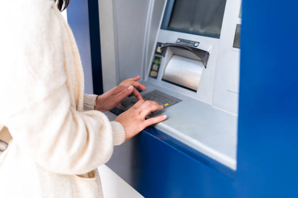 istock Close-Up of Womans Hands Using ATM Keypad 2161380138