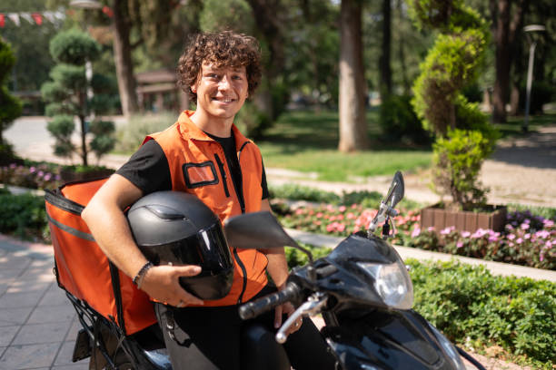 istock Male Courier on Motorcycle in the Park 2161380877