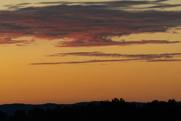 Dramatic sunset on the open plains with mountains in the background