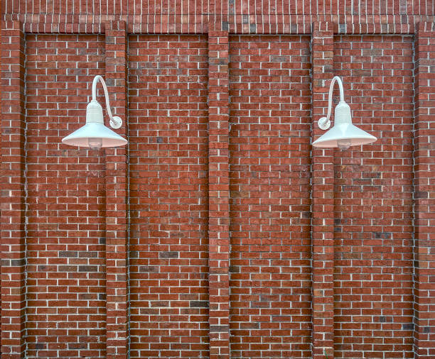 istock Red brick wall has real character has two goose neck shaded lamps for  use as a background 2161383888
