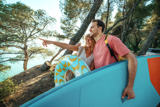 istock Cheerful young couple going on beach together 2161383953