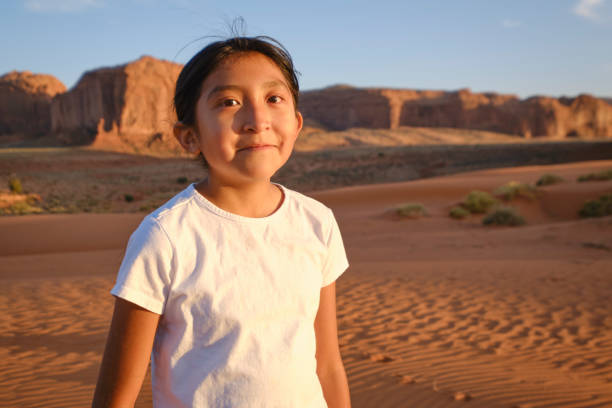 A Native American Navajo young girl playing in the desert at Monument Valley USA.