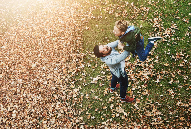istock Dad, boy and happy with lifting in park for fun with bonding, care and support. Relationship, parent and son as family with playing in garden for love, trust and child development or growth 2161387033