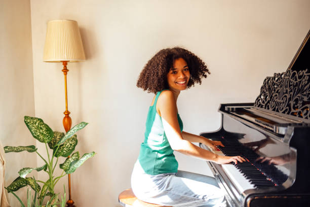 istock Young black lady playing a piano 2161387055