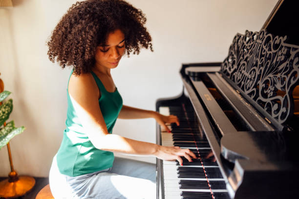 istock Young black lady playing a piano 2161387059