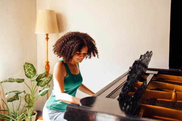 istock Young black lady playing a piano 2161387067