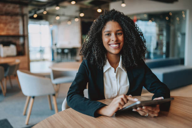 istock Young businesswoman using digital tablet looking at camera 2161387227