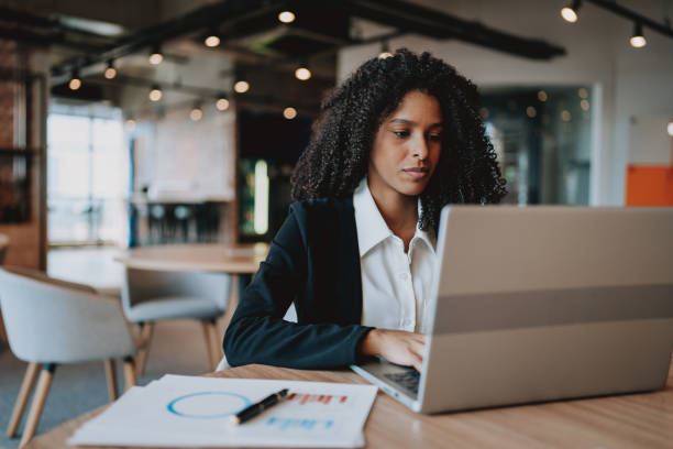 istock Young businesswoman using laptop at desk 2161387258