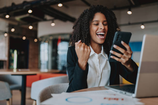 istock Young woman excitedly celebrating using laptop 2161387317
