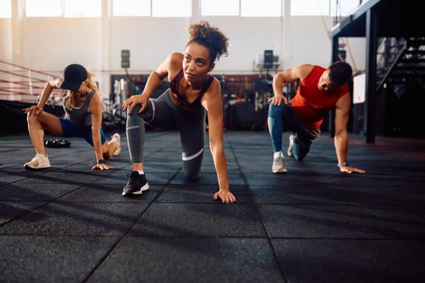 istock Athletic people doing stretching exercises while working out in health club. 2161387578