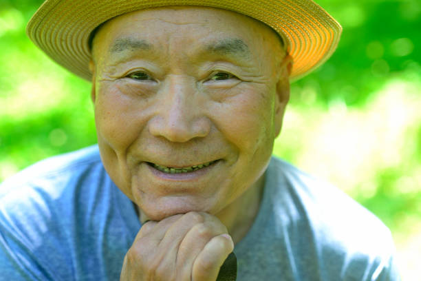 istock Smiling old man walking with a cane 2161389019