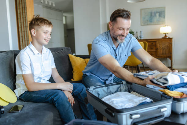 istock Father and son packing for a trip 2161393000