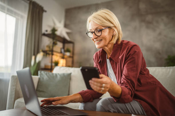 istock Mature senior woman work from home and use mobile phone on break 2161393019