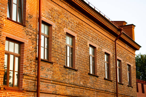 istock An old brick building. Vintage design, brick house architecture. Structure with red brick windows. 2161394895
