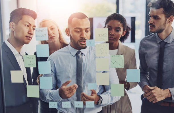 istock Collaboration, planning and window with business people in workshop at office for upskill development. Conversation, glass and meeting with employee team in corporate workplace for strategy or vision 2161395196