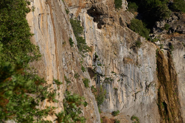 istock Scenic cliff face with lush foliage and beautiful brown rock formations during daytime 2161395764