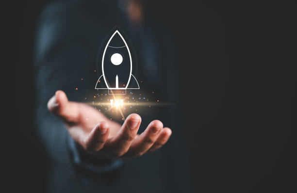 istock Startup business concept, Businessman holding rocket icon on virtual screen for fast start up business. Strategic planning and business success. 2161396326