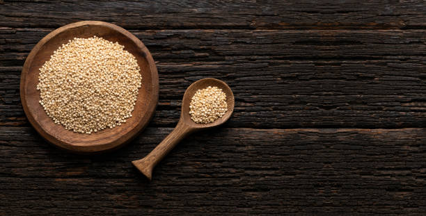 istock Chenopodium quinoa - White organic quinoa seeds in the bowl and spoon - Rustic background 2161396614
