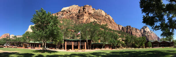 Panoramic shot of the Zion Lodge dwarfed by the magnificent rockface of Zion National Park, Utah
