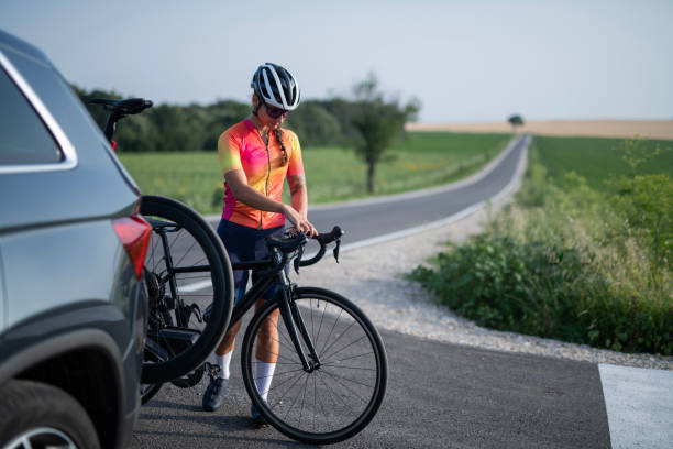 istock Female road cyclist adjusting her tracking computer before the ride. 2161399977