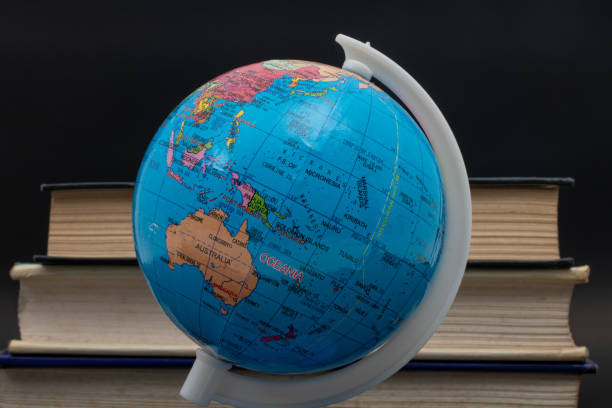 istock Globe and old books on black background. Back to school 2161399990
