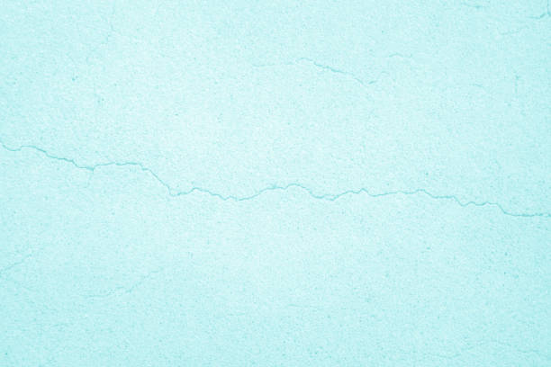 Pastel blue crack concrete stone texture for background in summer wallpaper. Cement and sand wall of tone vintage. Decorative abstract wall of light cyan color painted, Beautiful mint green decor.