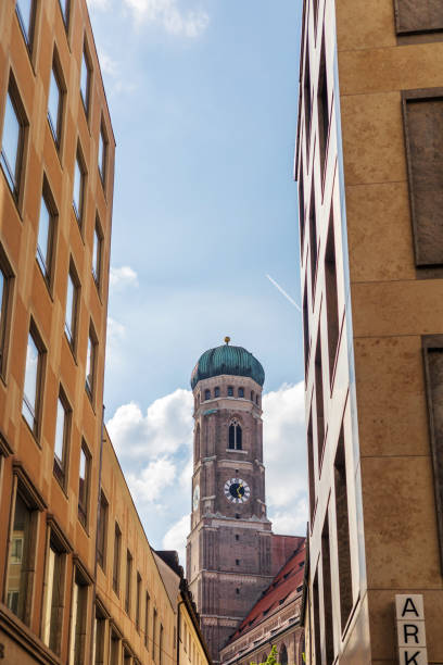 Munich, Germany - May 09, 2024: Frauenkirche Clock Tower View from Munich Street