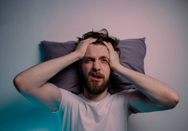 istock Top view man having trouble sleeping  head on a pillow hands on the head 2161407534