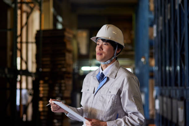 istock A man wearing work clothes inspecting a factory 2161410485