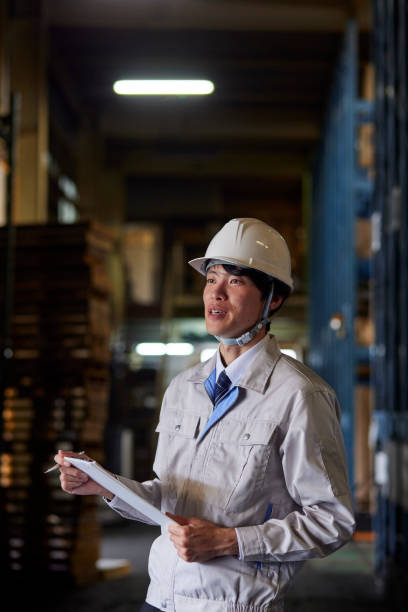 istock A man wearing work clothes inspecting a factory 2161410491