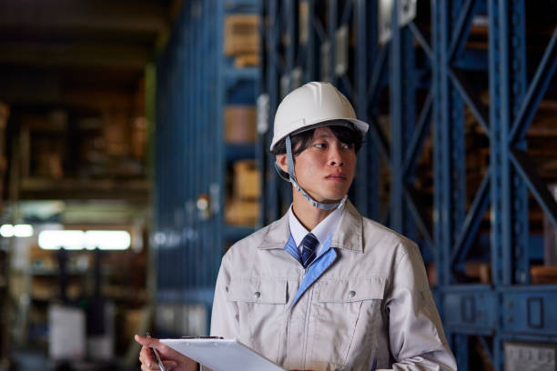 istock A man wearing work clothes inspecting a factory 2161410498
