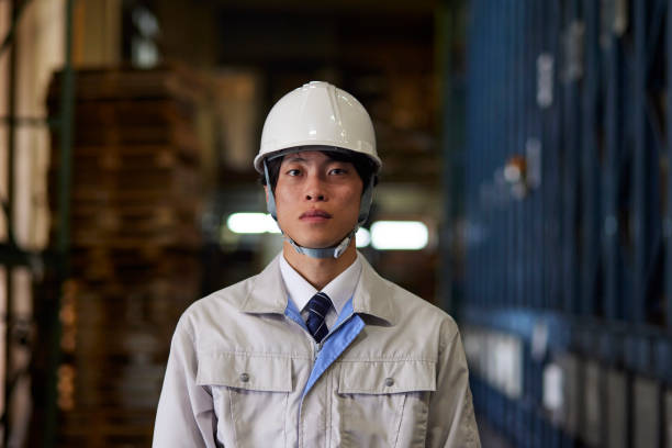 istock A man wearing work clothes inspecting a factory 2161410522