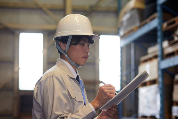 istock A man wearing work clothes inspecting a factory 2161410529