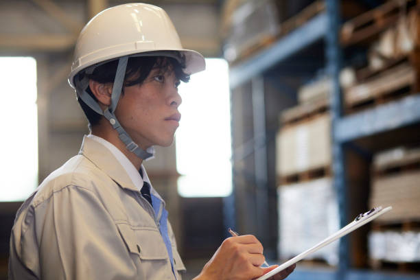 istock A man wearing work clothes inspecting a factory 2161410541