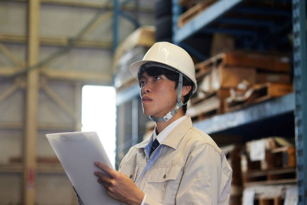 istock A man wearing work clothes inspecting a factory 2161410556
