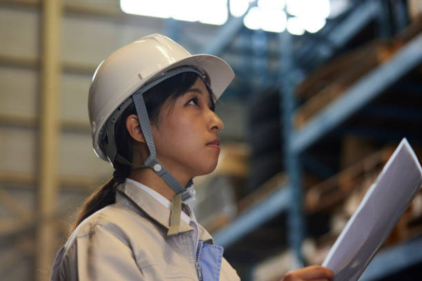 istock A woman in work clothes inspecting a factory 2161410563