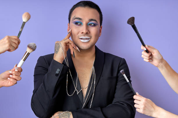 istock thoughtful transvestite male model in black jacket surrounded by beauticians with brushes 2161412500