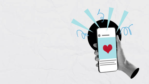 A human hand holding a mobile phone with a red heart on the screen with a colored background. Collage art